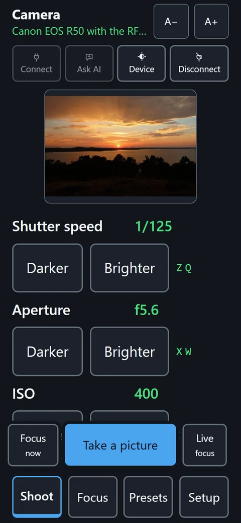 The evo.ablecamera shoot screen on a phone: the viewfinder shows a sunset over a lake, and under it shutter speed, aperture and ISO each have a large Darker and Brighter button with a single key beside them